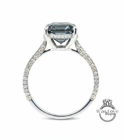 A silver engagement ring with a large, dark blue gemstone set in the center.