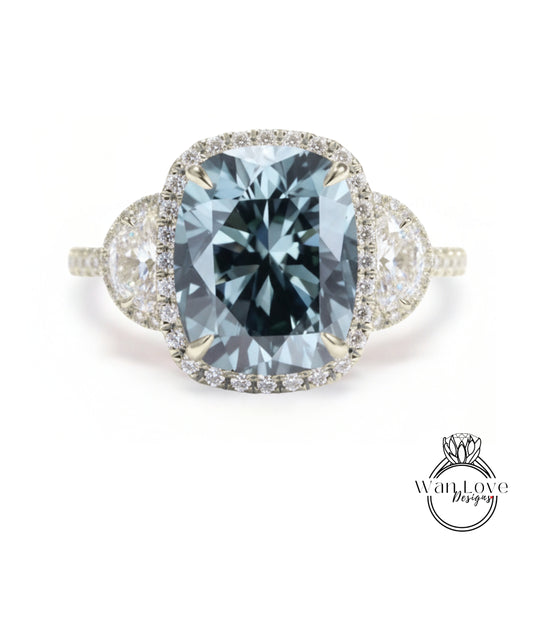 A stunning engagement ring with a large, blue gemstone set in a halo of smaller diamonds, surrounded by a delicate band of white diamonds.