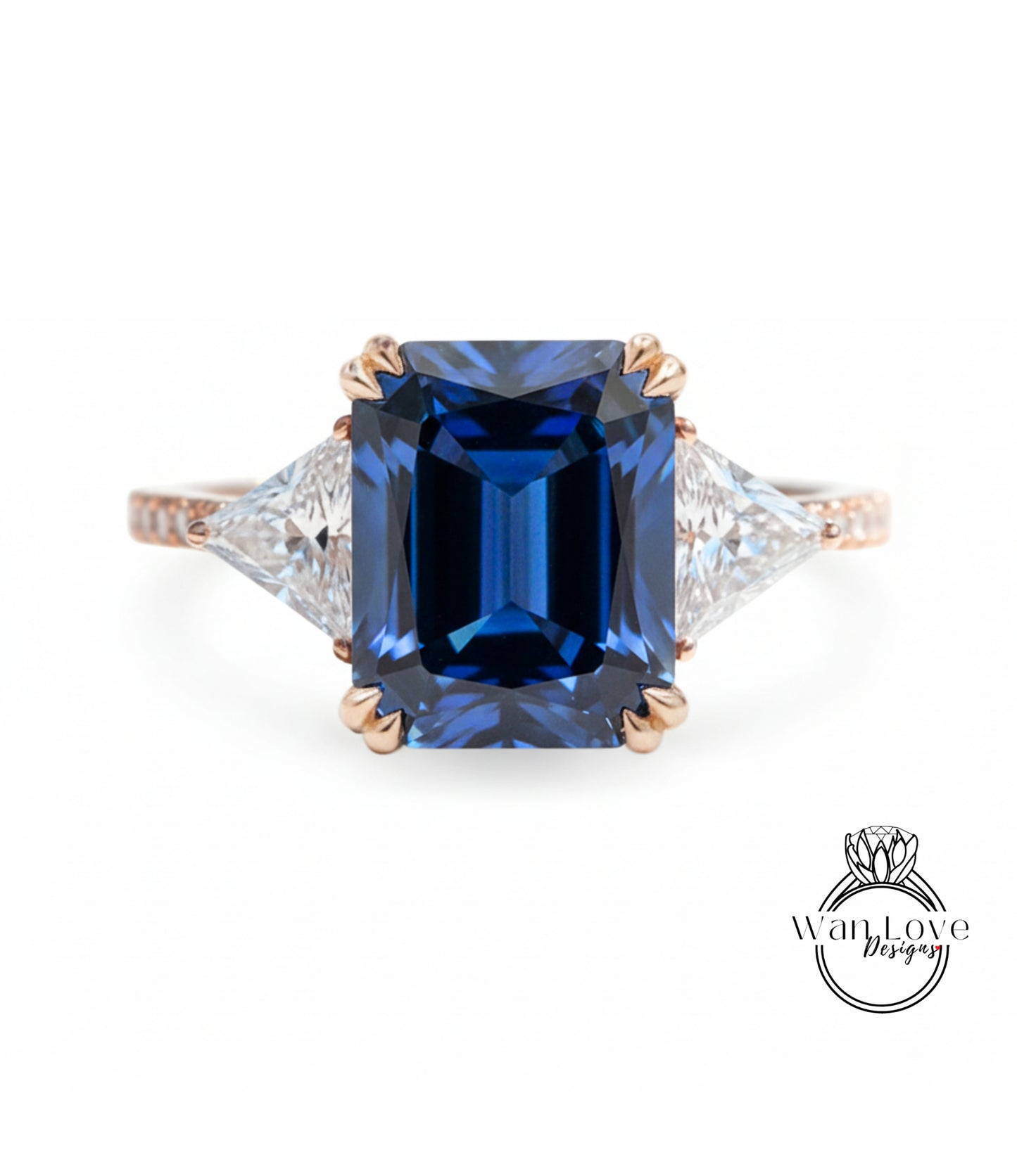 A stunning blue gemstone engagement ring with a large central blue gemstone surrounded by smaller diamonds on either side.