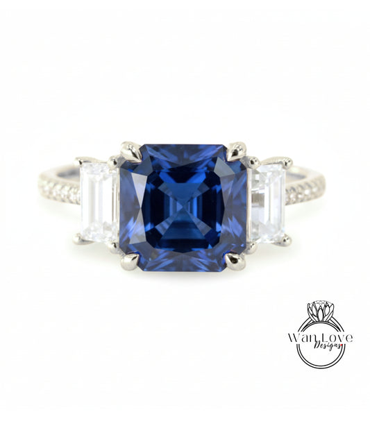 A close-up of a diamond ring with a large blue gemstone in the center, surrounded by smaller diamonds.