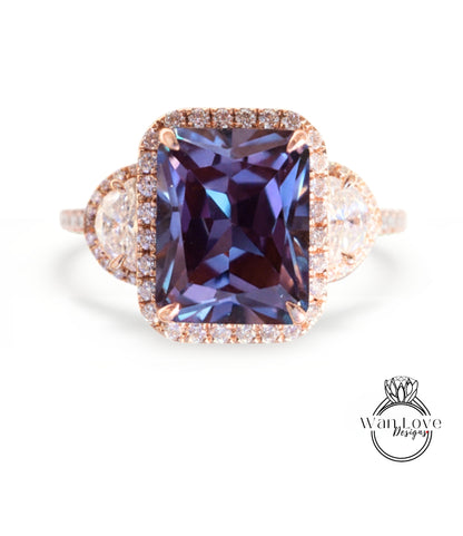 A large, purple gemstone ring with a halo of smaller diamonds around it, set in a gold-toned metal band.