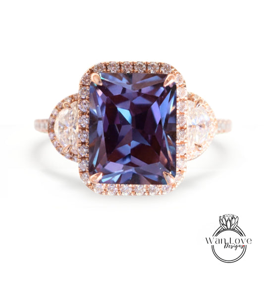 A large, purple gemstone ring with a halo of smaller diamonds around it, set in a gold-toned metal band.