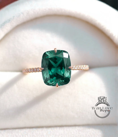 A close-up image of a gold ring with a large, green gemstone set in the center.