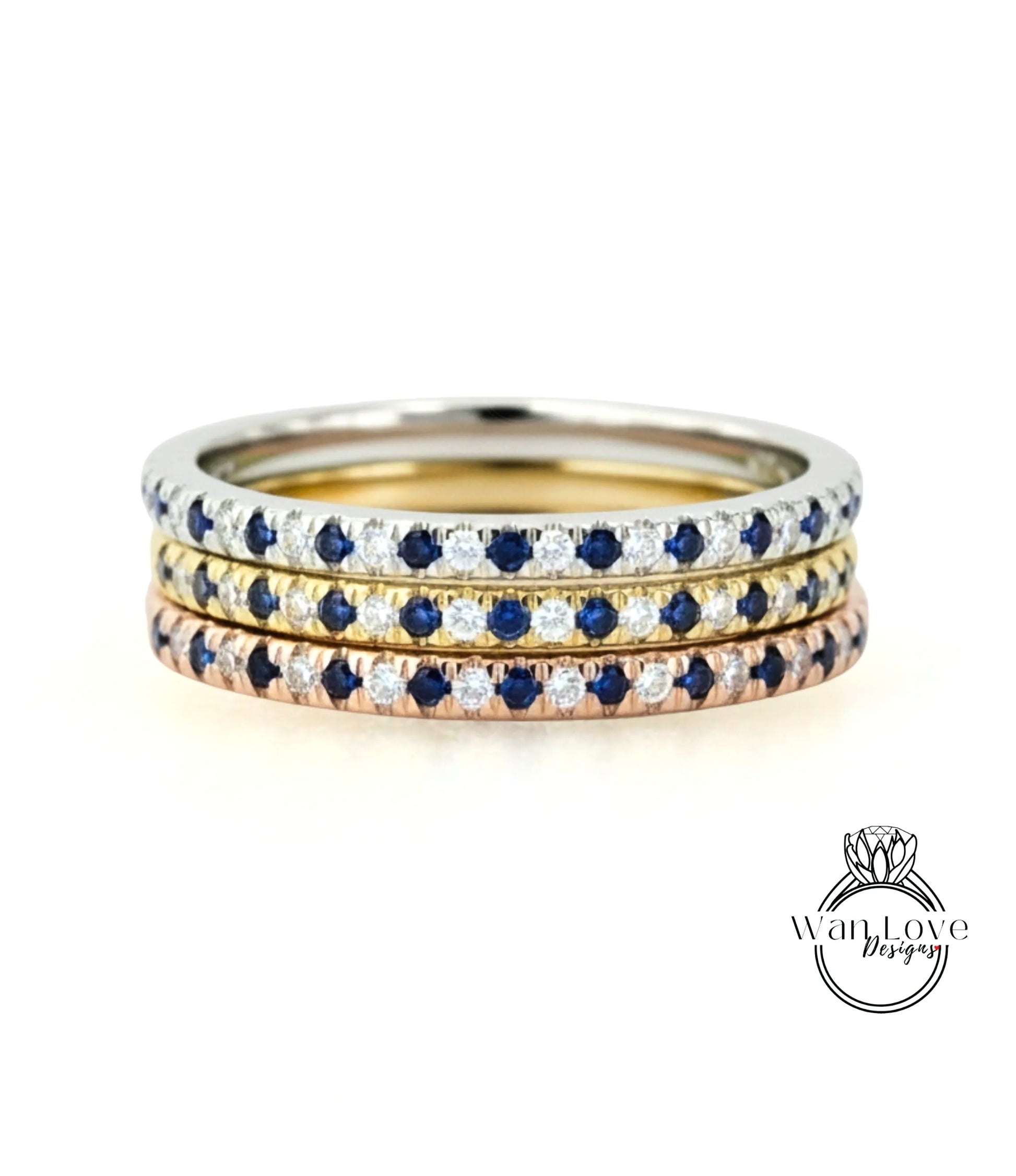 A stack of three rings with blue sapphires and diamonds set in a silver band.