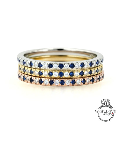 A stack of three rings with blue sapphires and diamonds set in a silver band.