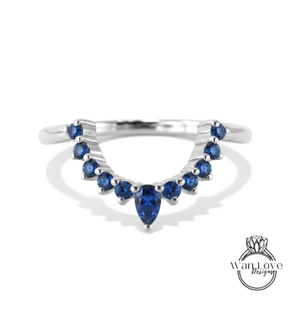 A silver ring with a large blue gemstone at the center, surrounded by smaller blue gemstones.