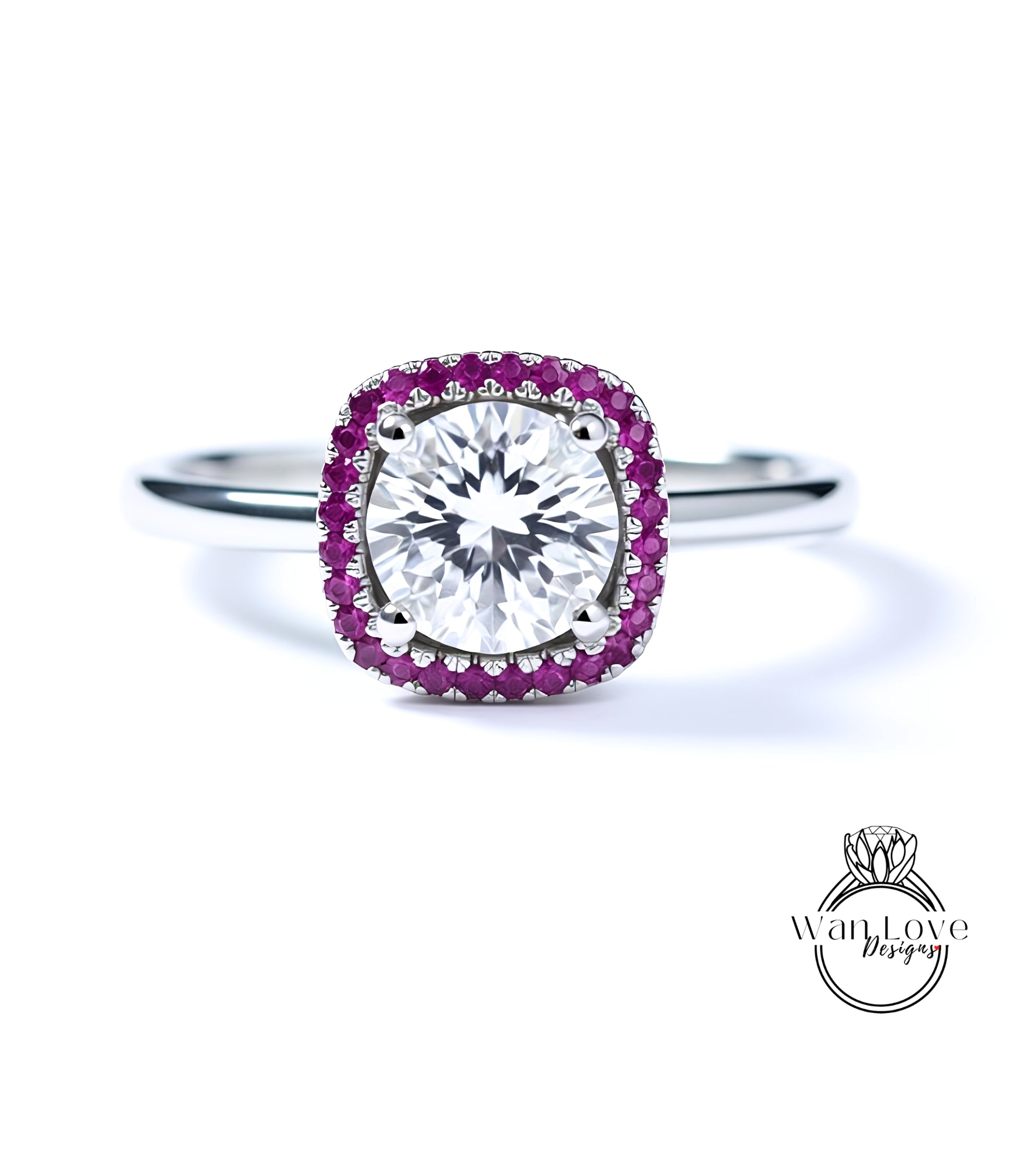 A diamond engagement ring with a large central diamond surrounded by a halo of smaller diamonds and a border of red gemstones.
