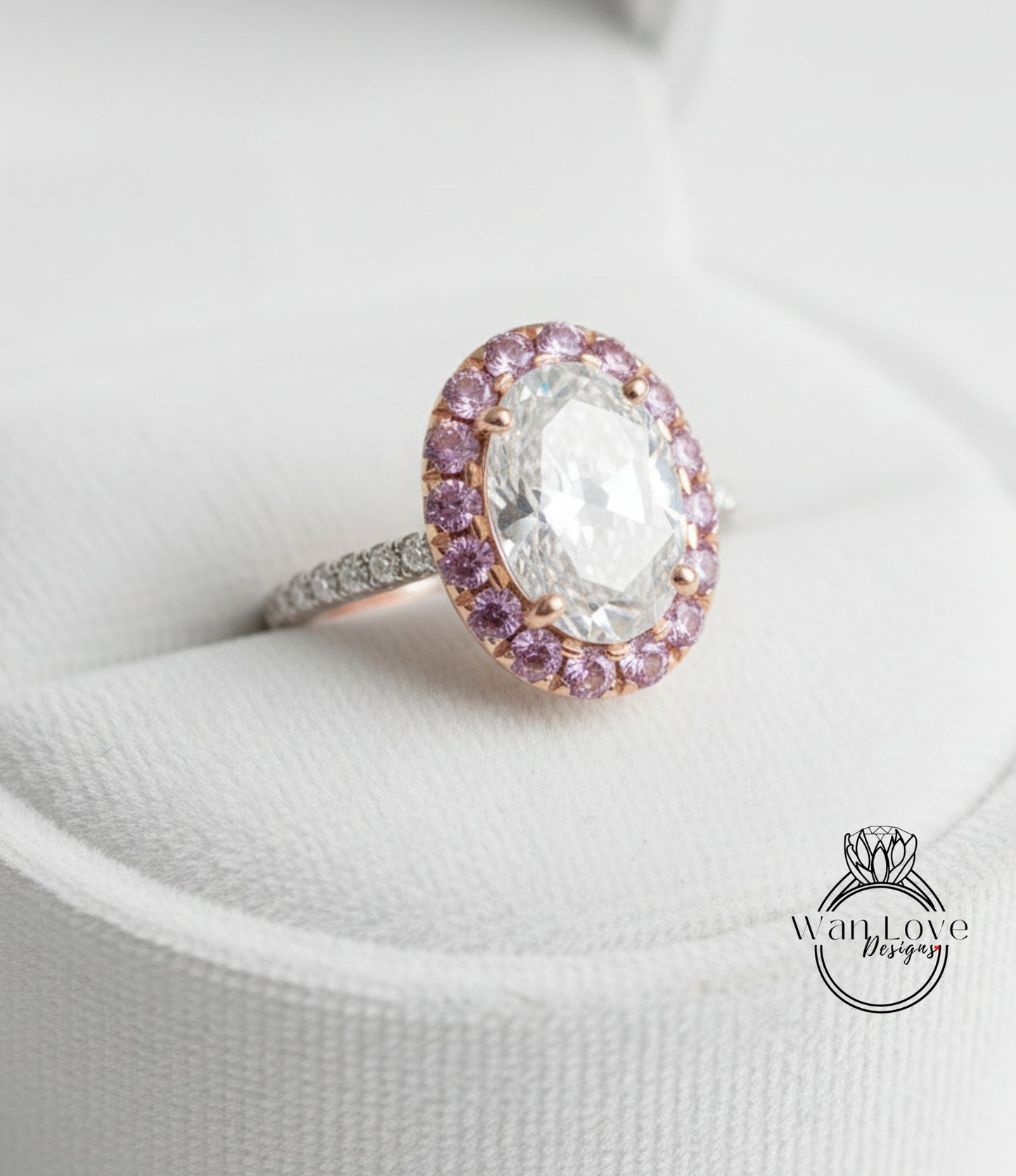 A close-up image of a diamond ring with a large oval-shaped diamond surrounded by a halo of smaller diamonds and colored gemstones.