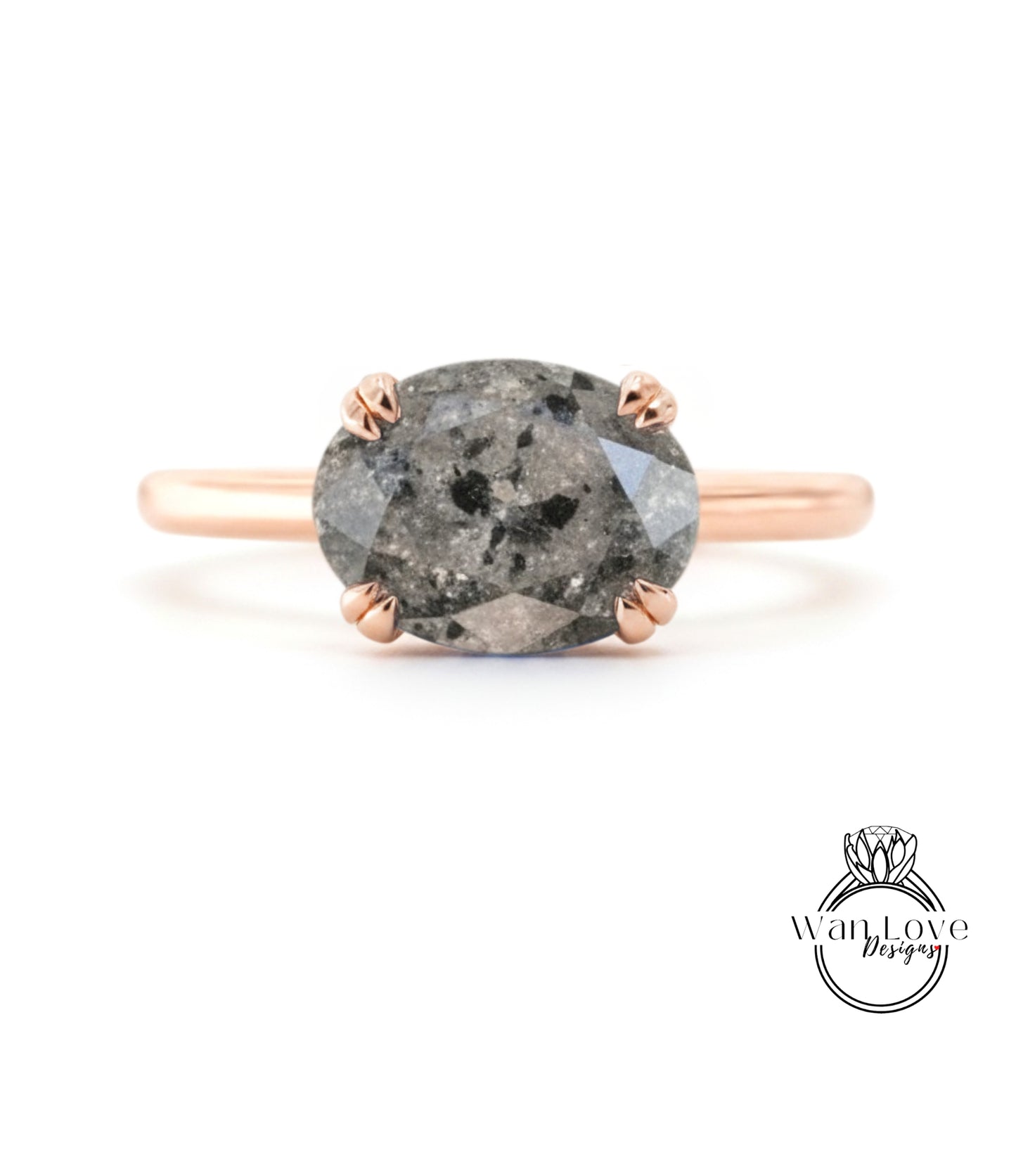 A rose gold ring with a large oval-shaped diamond as the centerpiece.