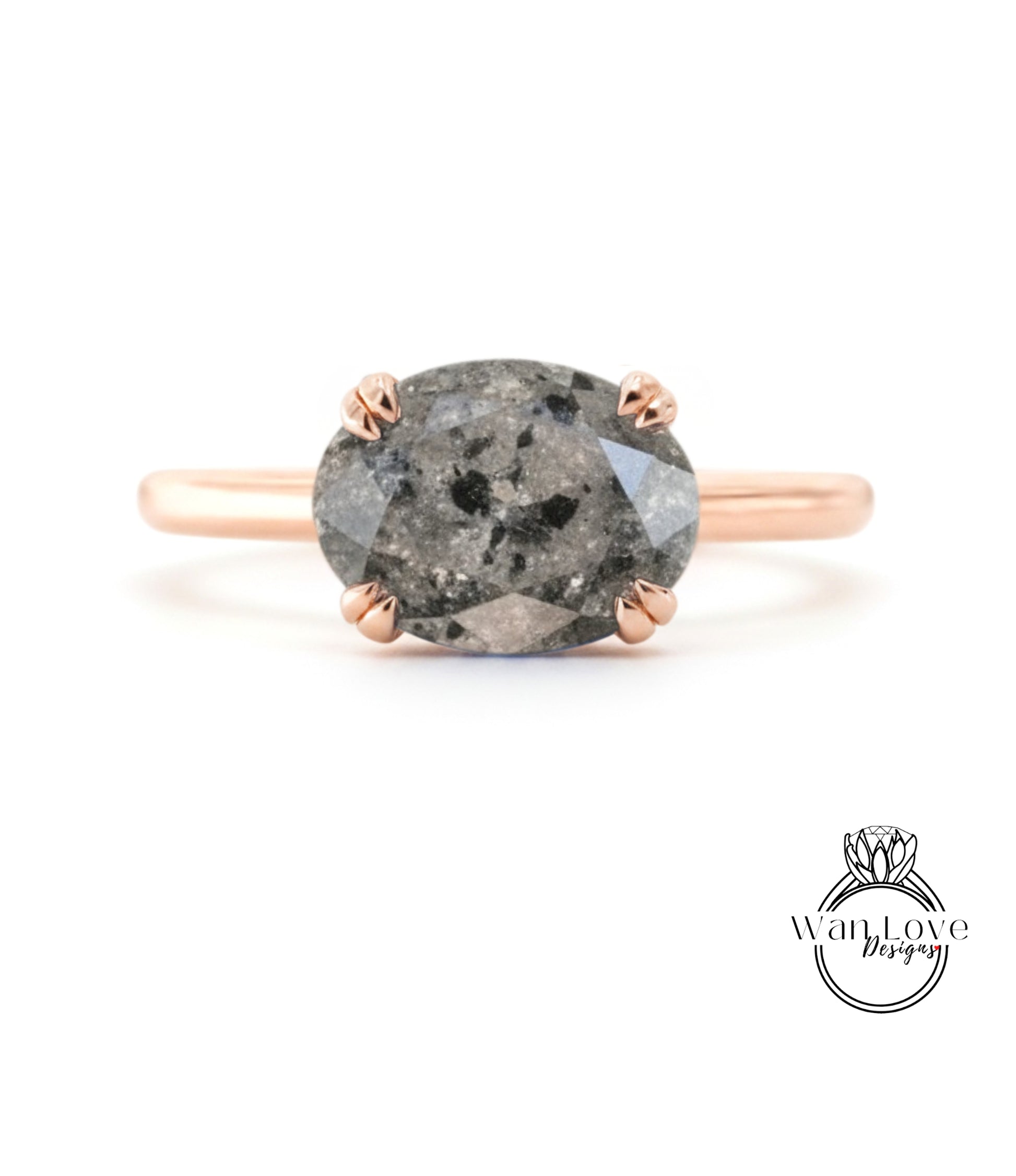 A rose gold ring with a large oval-shaped diamond as the centerpiece.