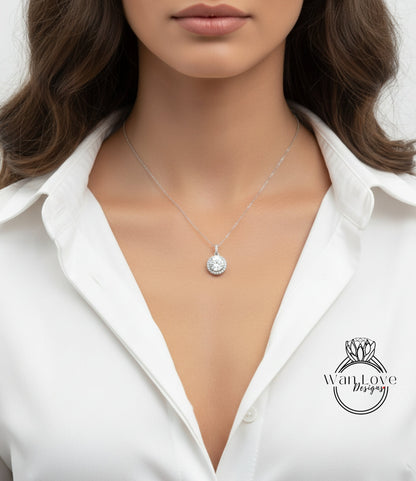 A close-up of a woman wearing a white shirt and a necklace with a pendant.