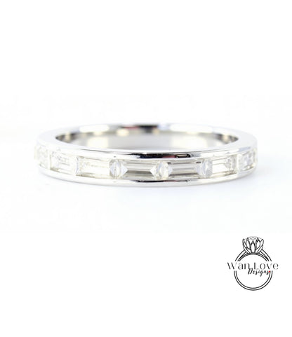 A silver band ring with a row of small diamonds set in it.