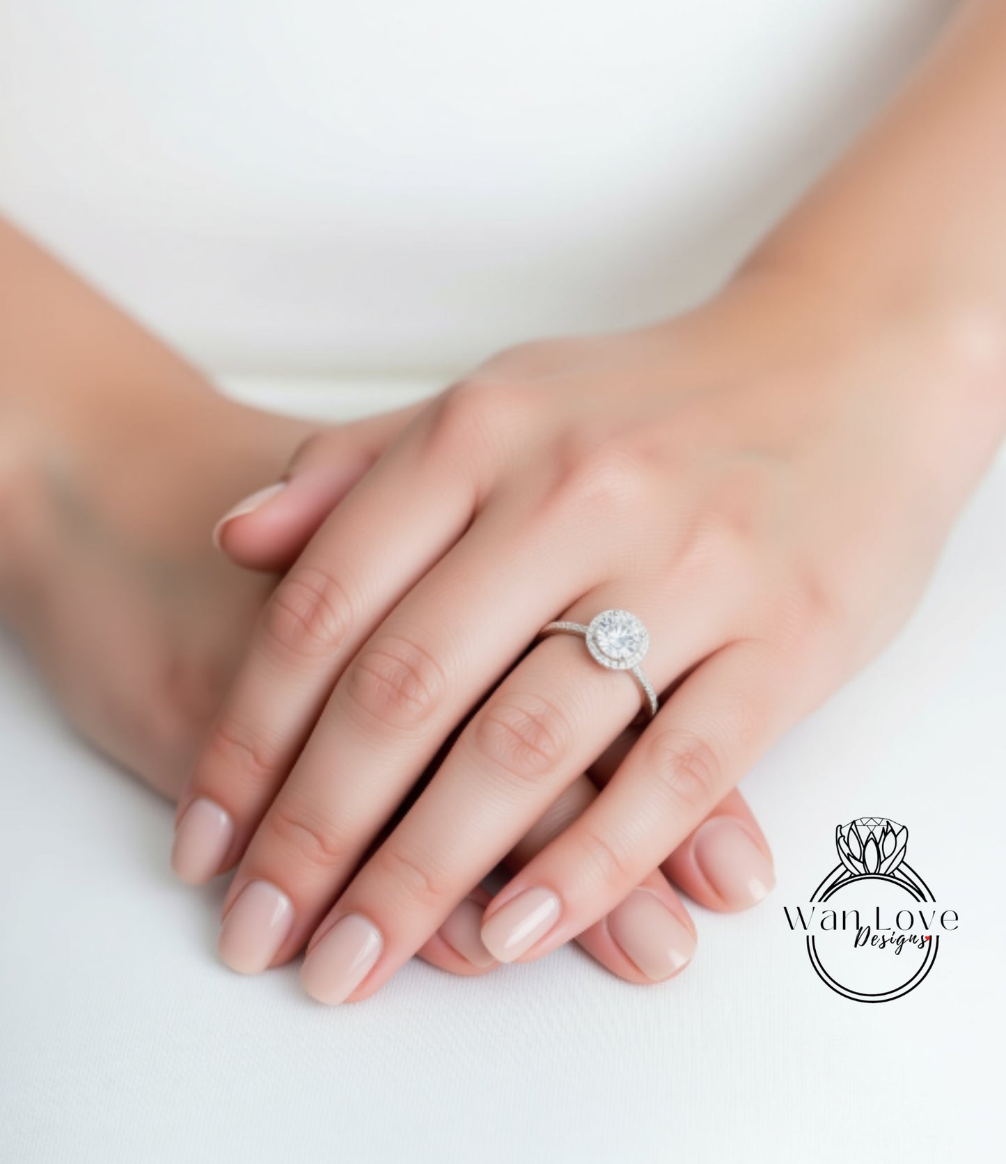 A close-up image of a person's hands wearing a diamond engagement ring.