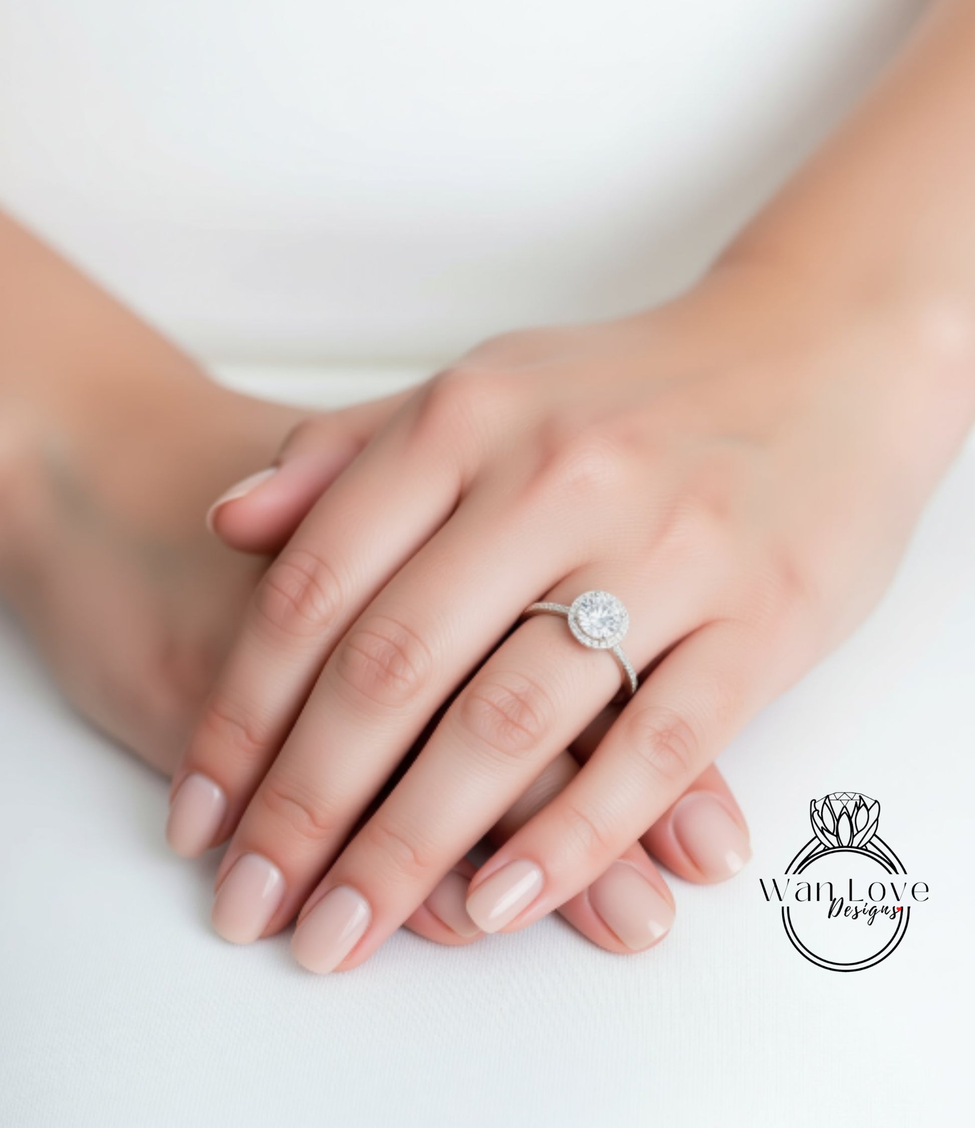 A close-up image of a person's hands wearing a diamond engagement ring.