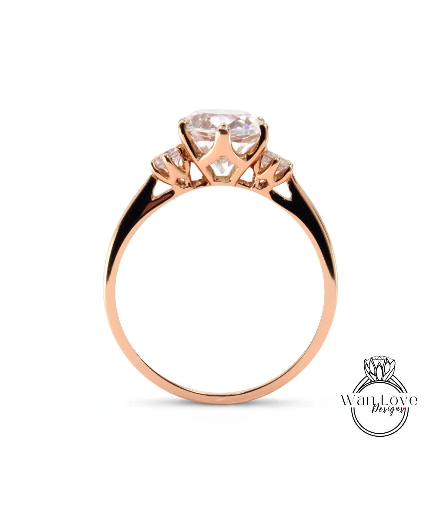 A gold ring with a large central diamond and three smaller diamonds on either side.