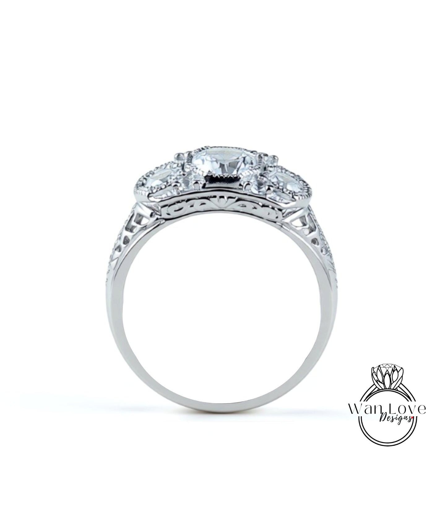 A silver ring with a large central diamond surrounded by smaller diamonds, showcasing intricate metalwork and detailing.
