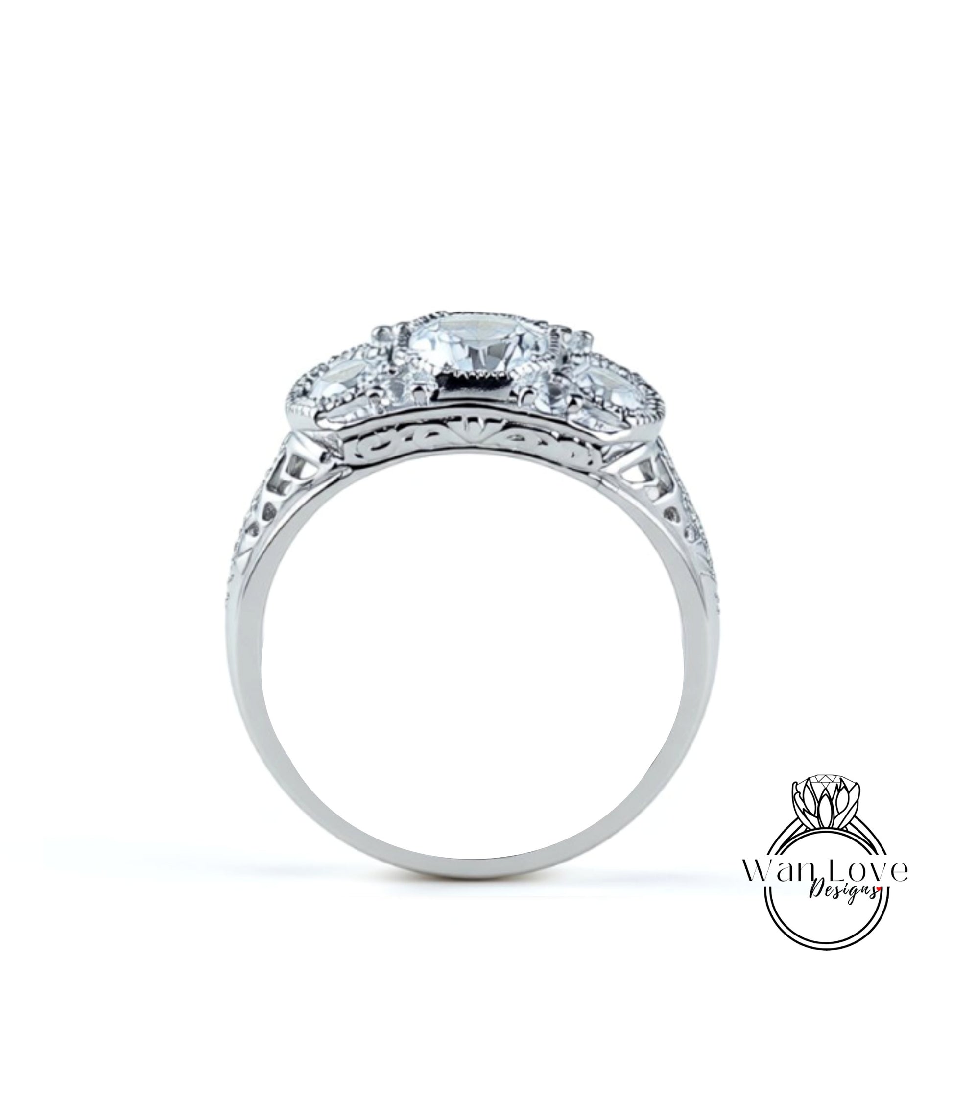 A silver ring with a large central diamond surrounded by smaller diamonds, showcasing intricate metalwork and detailing.