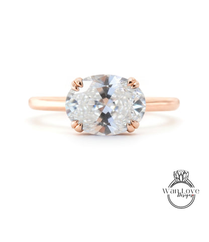 A rose gold engagement ring with a large, clear gemstone set in the center.
