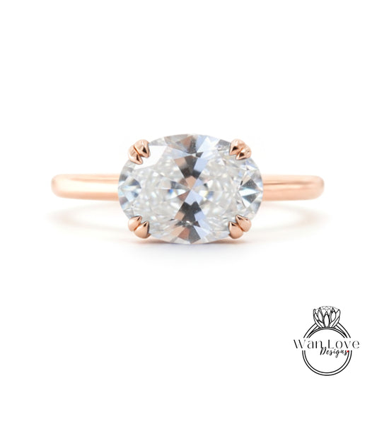 A rose gold engagement ring with a large, clear gemstone set in the center.