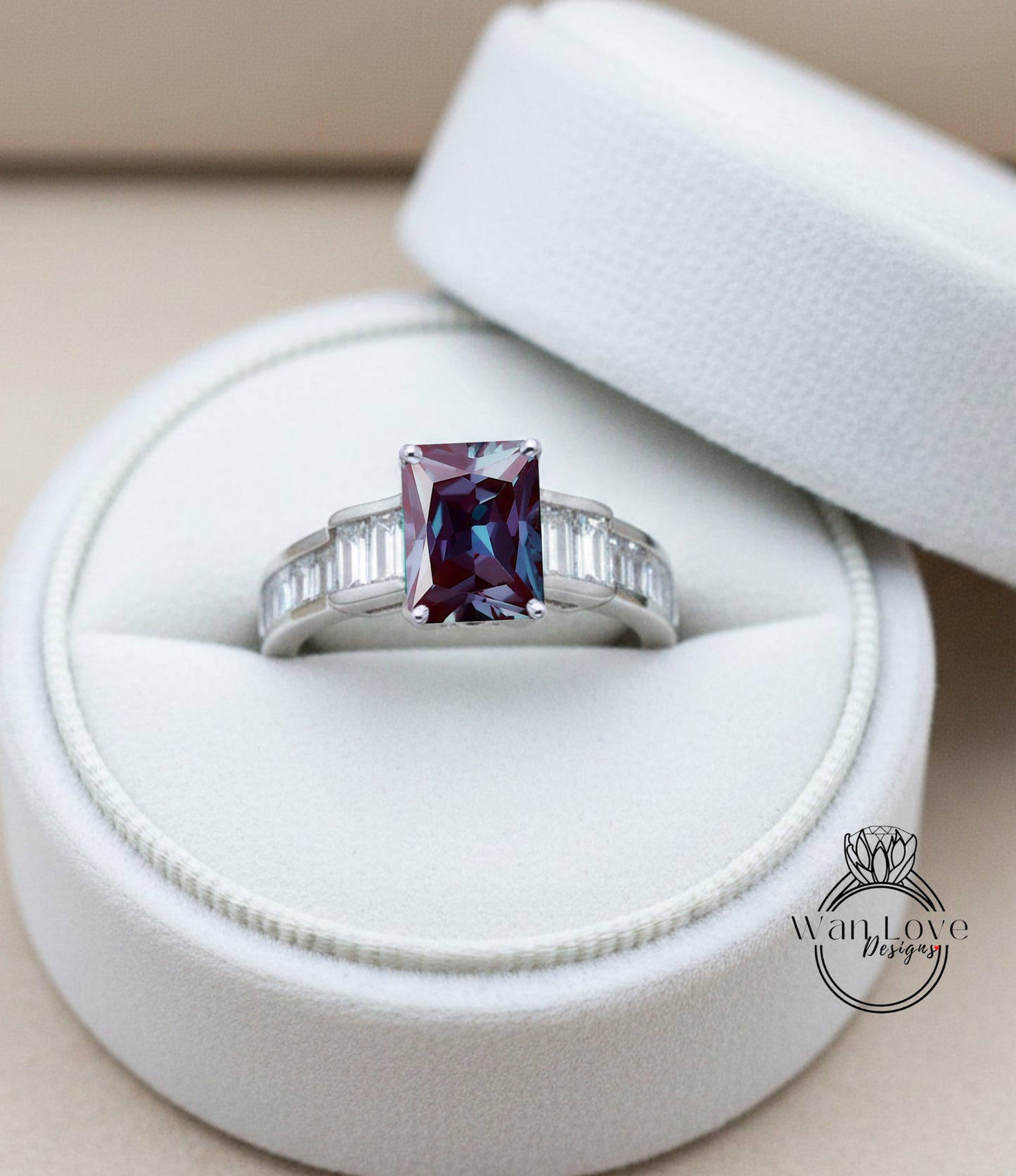 A diamond engagement ring with a large purple gemstone set in a silver band, displayed in a white jewelry box.