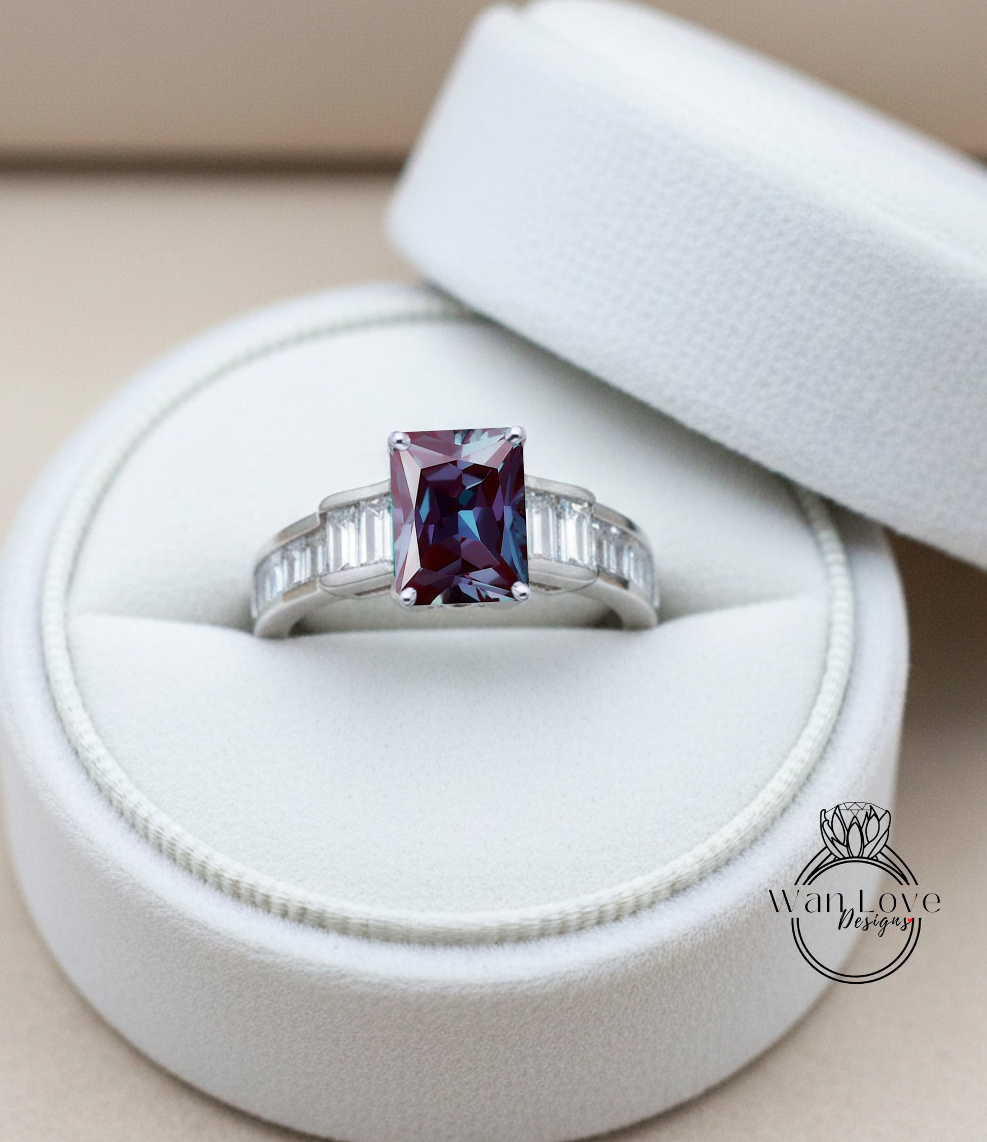 A diamond engagement ring with a large purple gemstone set in a silver band, displayed in a white jewelry box.