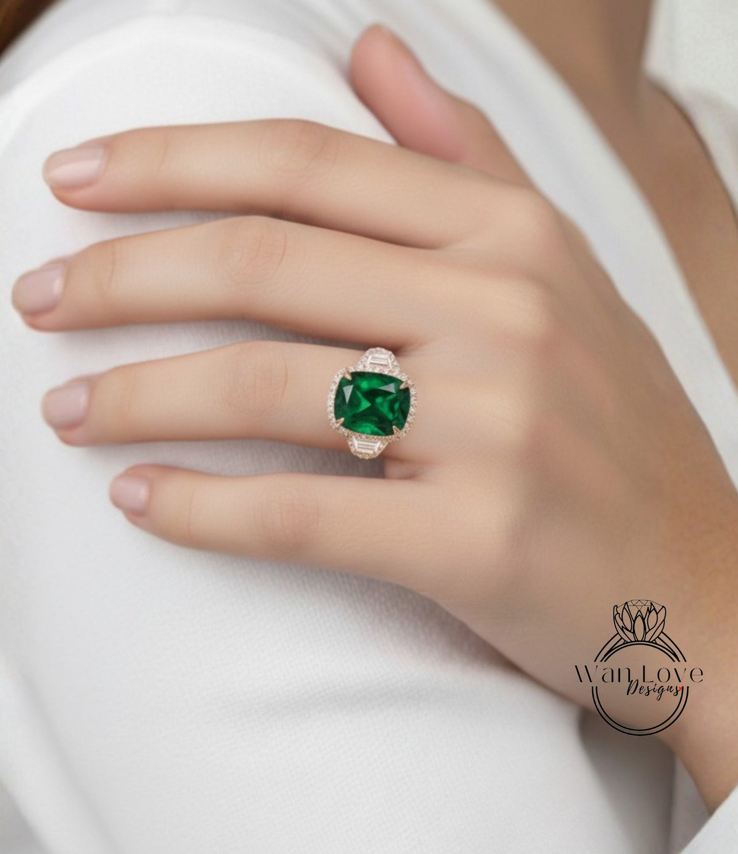 A close-up of a person's hand wearing a large, green gemstone ring on the ring finger.