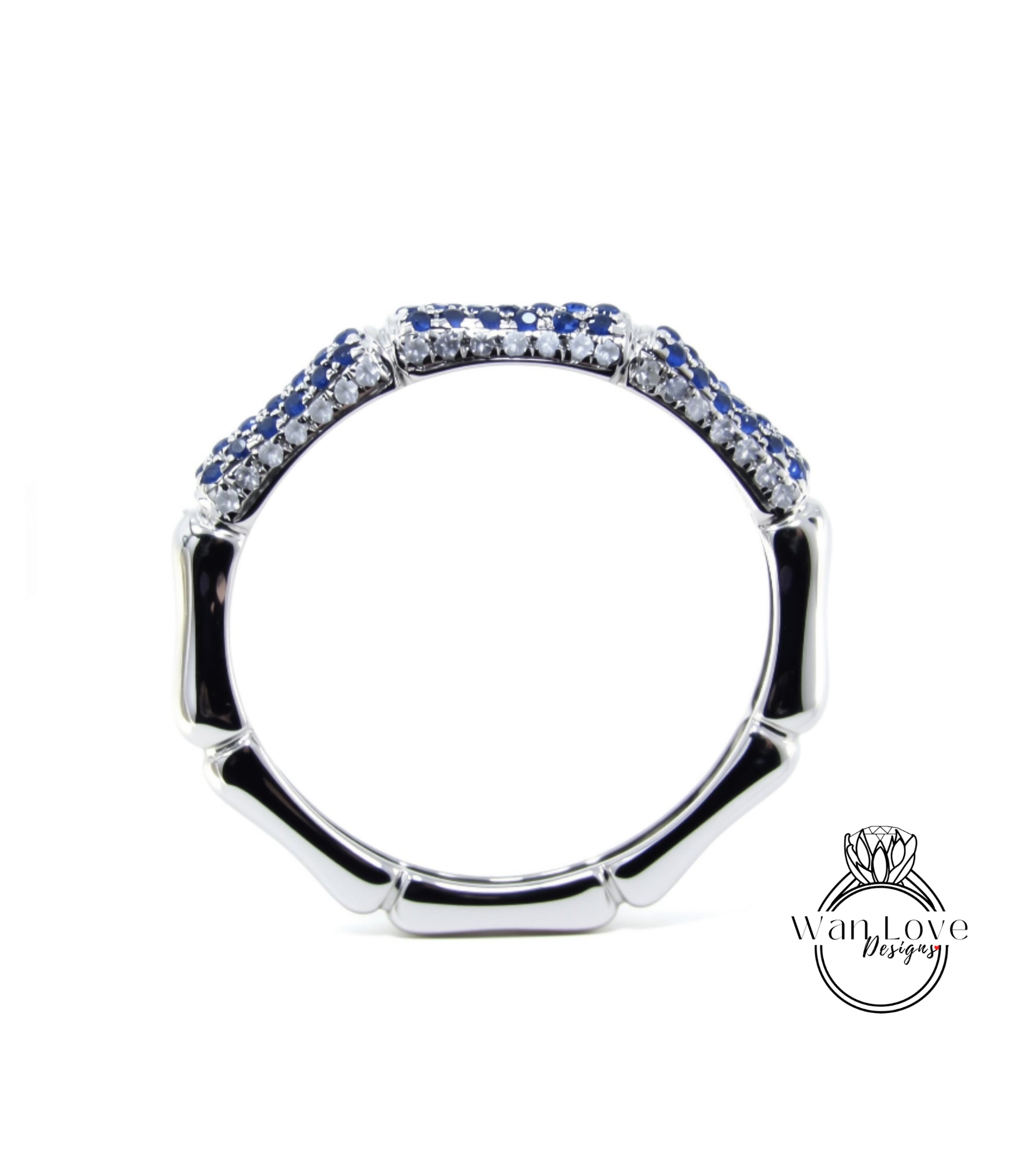 A silver ring with blue gemstones, including sapphires, set in a decorative pattern.