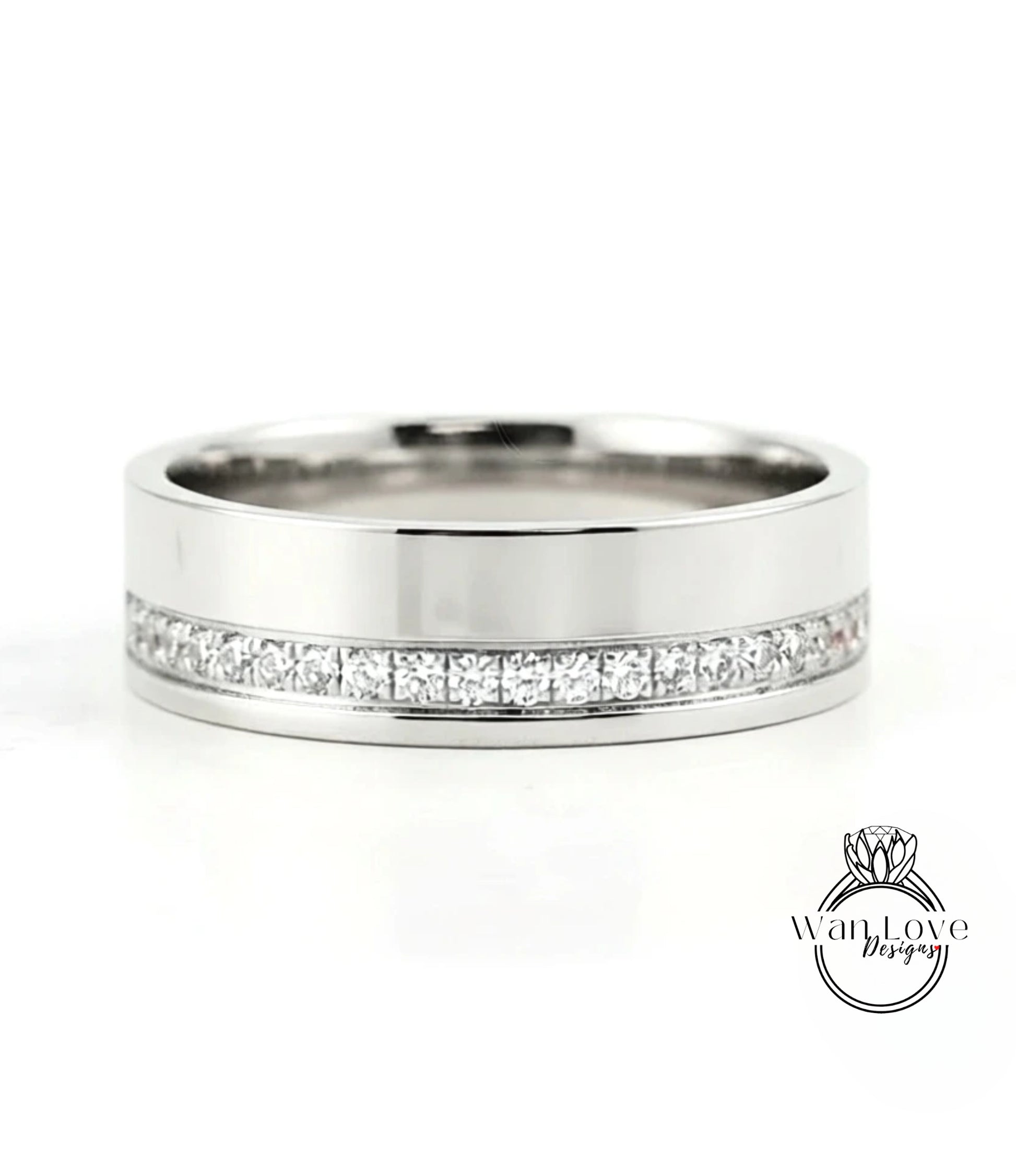 A silver-colored wedding band with a row of diamonds set along the inside of the band.