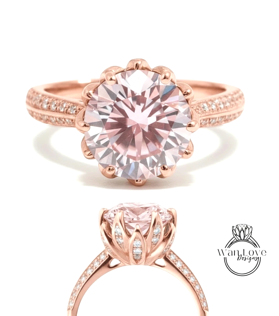 a beautiful pink diamond engagement ring with a large central diamond surrounded by smaller diamonds on the band.