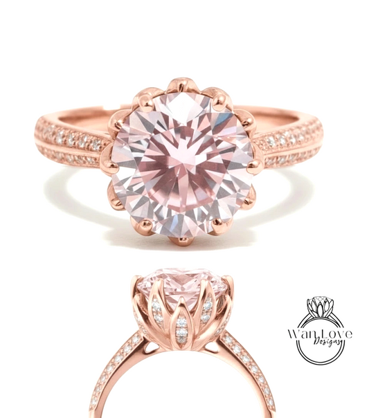 a beautiful pink diamond engagement ring with a large central diamond surrounded by smaller diamonds on the band.
