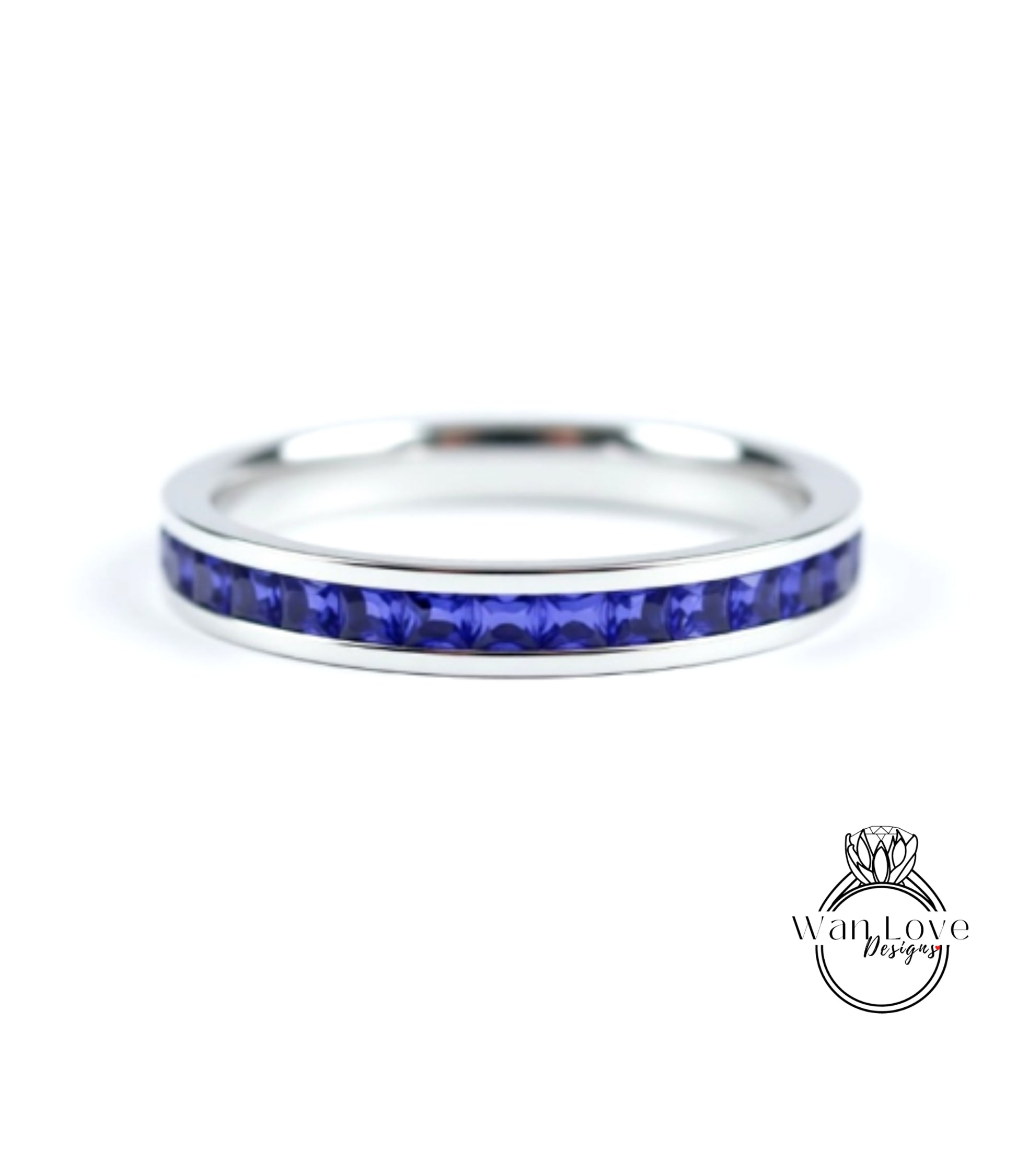 A silver ring with a row of blue sapphire gemstones set in the band.