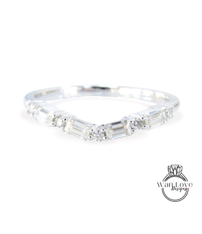 A silver ring with a unique design featuring a series of small diamonds arranged in a curved pattern.