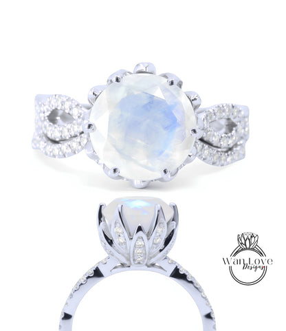 a beautiful engagement ring with a large moonstone set in a silver band adorned with small diamonds.
