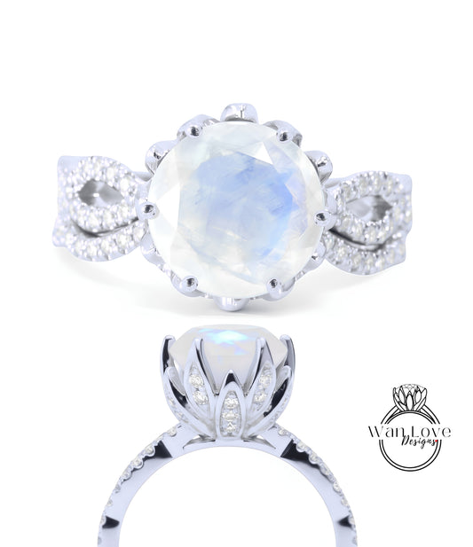a beautiful engagement ring with a large moonstone set in a silver band adorned with small diamonds.