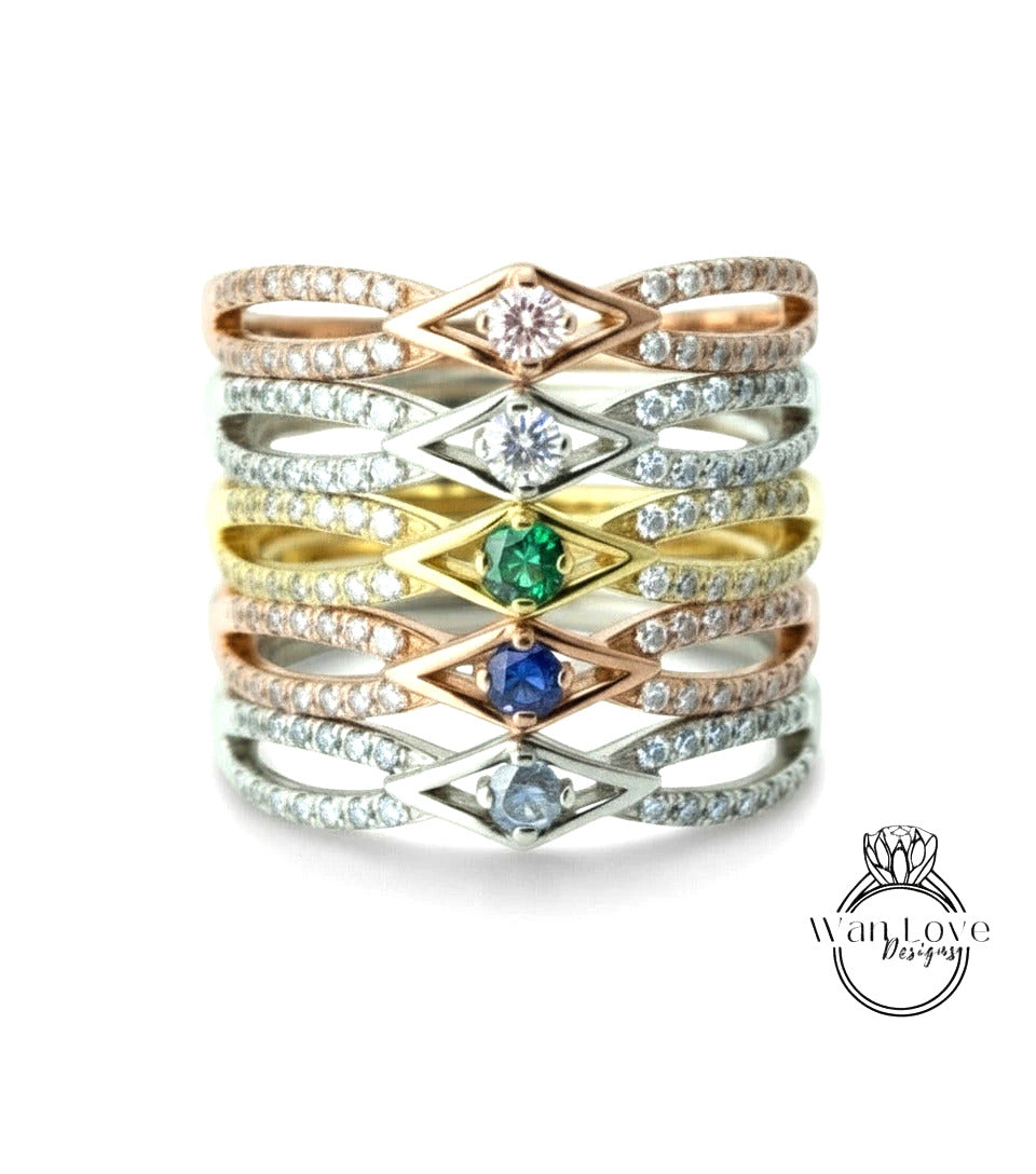 A ring with multiple layers of rings, each ring featuring a diamond and a gemstone. The rings are arranged in a stacked manner, creating a layered effect.