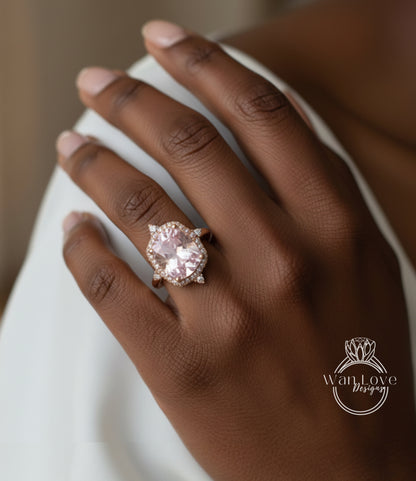 A close-up of a hand wearing a large, pink gemstone ring with a halo of smaller diamonds around it.