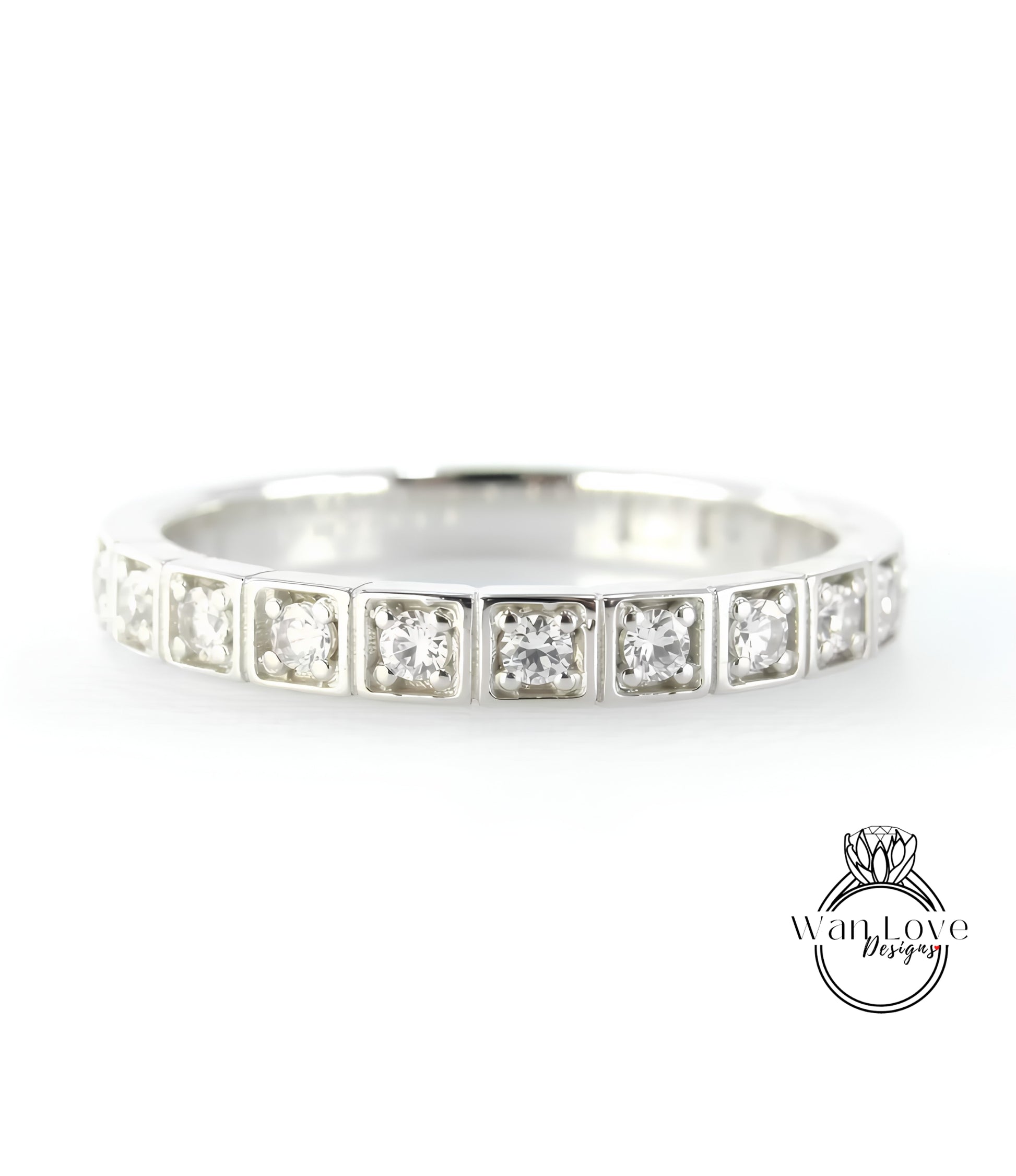 A silver band ring with a row of small diamonds set in the center.