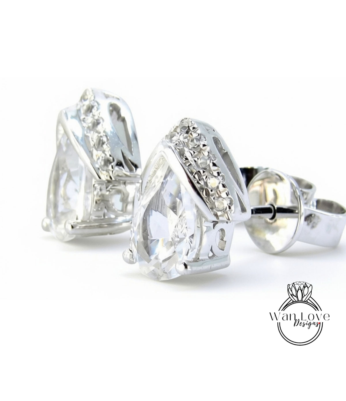 A pair of elegant silver earrings with large, clear gemstones set in a decorative metal frame.