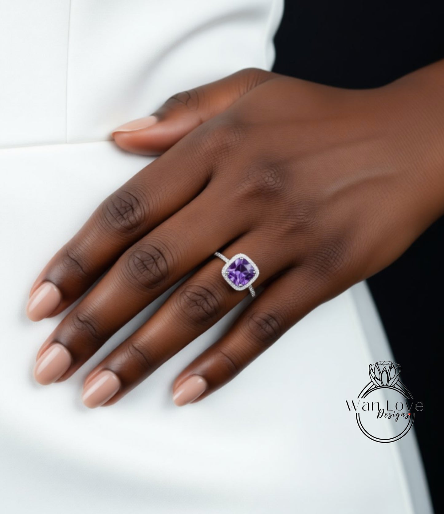 A close-up of a hand wearing a ring with a purple gemstone.