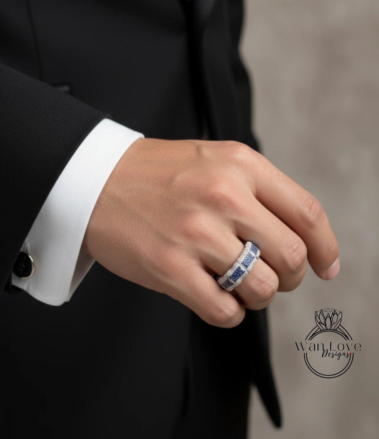 A close-up of a person's hand wearing a ring on the ring finger.