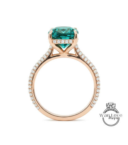 A rose gold engagement ring with a large, square-cut green gemstone set in the band, surrounded by small diamonds.