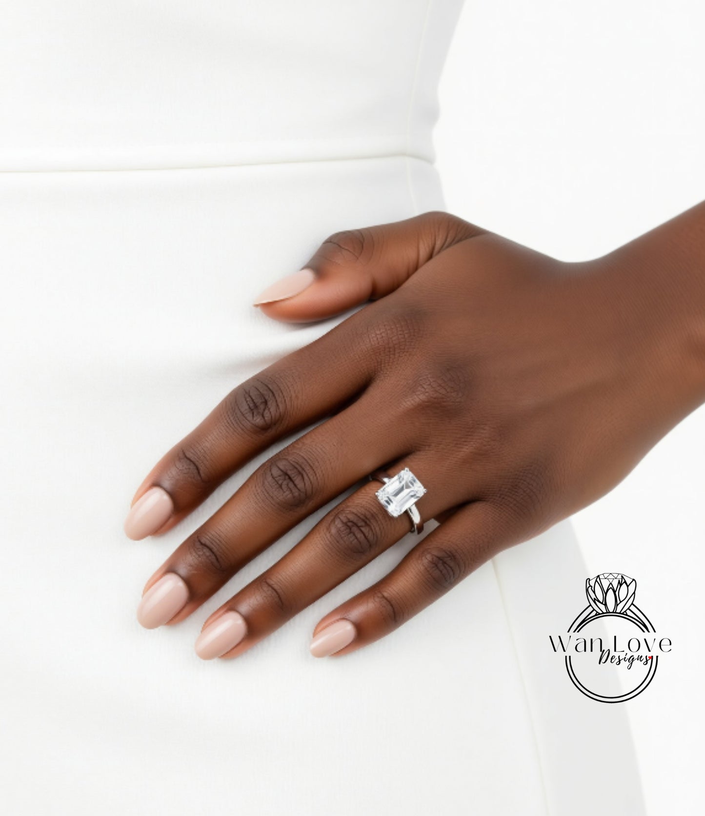 A close-up of a hand wearing a large diamond engagement ring.