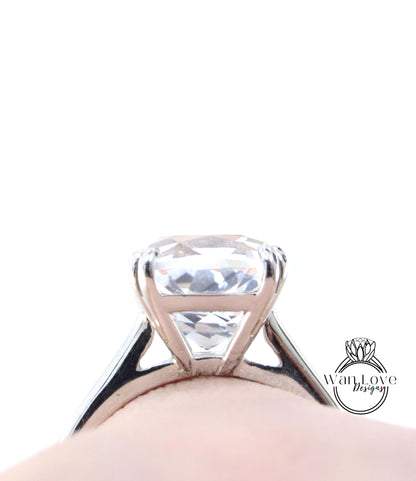 A close-up view of a large, clear gemstone set in a silver ring.
