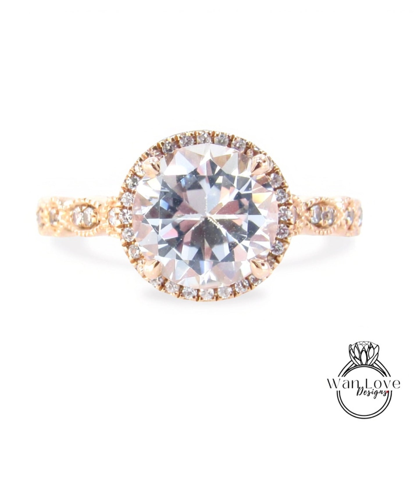 A beautiful engagement ring with a large round diamond set in a halo of smaller diamonds, surrounded by a delicate gold band.