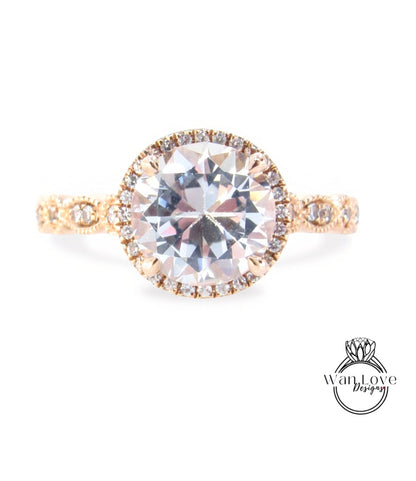 A beautiful engagement ring with a large round diamond set in a halo of smaller diamonds, surrounded by a delicate gold band.