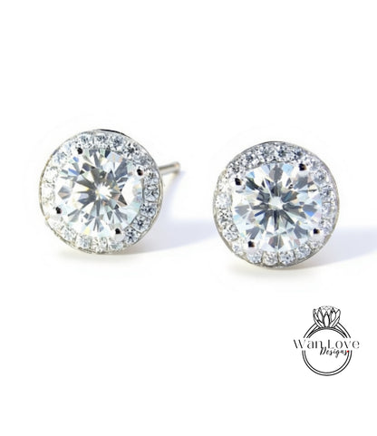 A pair of elegant earrings with large, clear gemstones set in a halo of smaller diamonds.