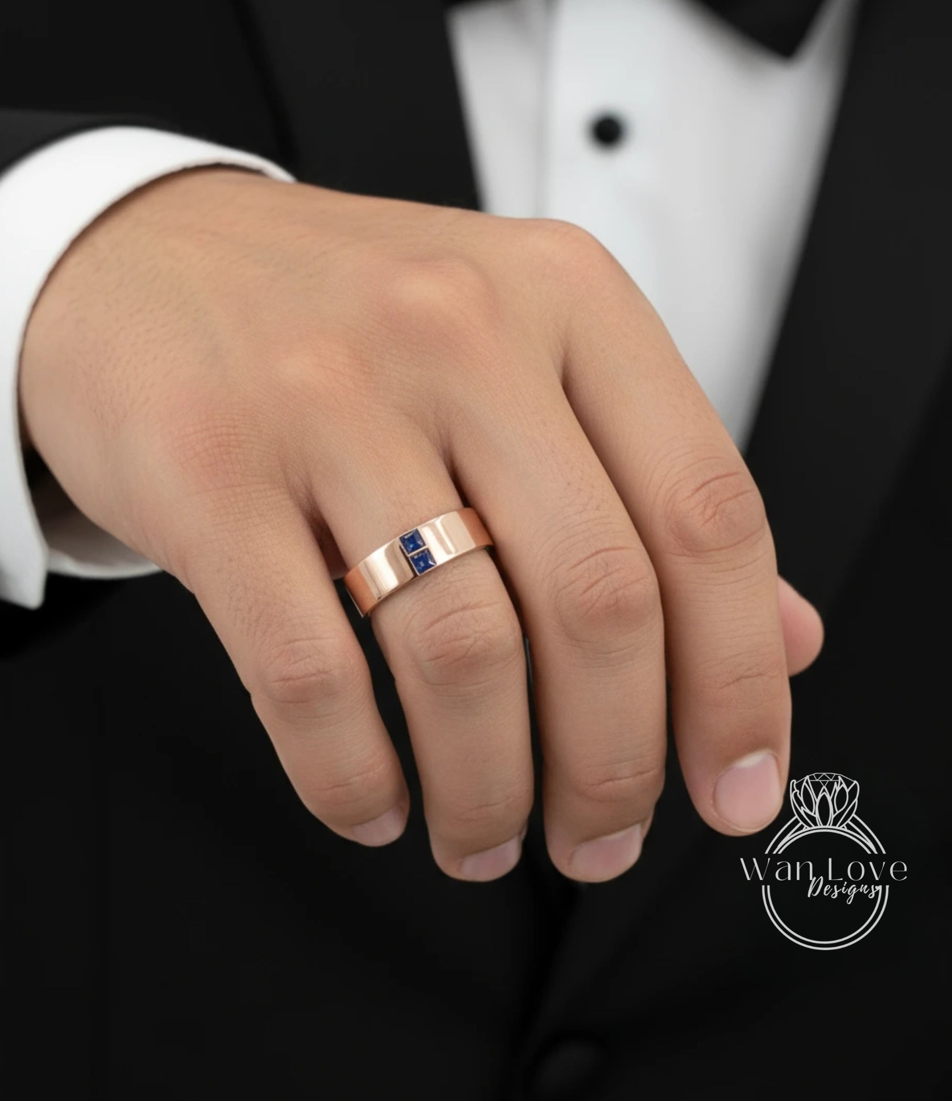 A close-up of a person's hand wearing a gold ring with a blue gemstone.