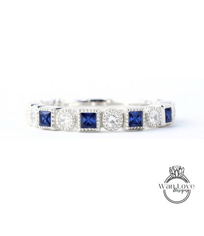 A silver and blue diamond-encrusted bracelet with square-shaped blue gemstones.