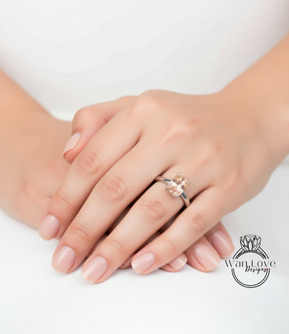 A close-up image of a person's hands with a ring on the finger, resting on a white surface.