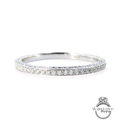 A silver band ring with a row of small diamonds set in it.